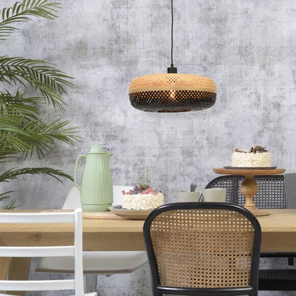 Pendant light Palawan in bamboo lit above a dining table in wood
