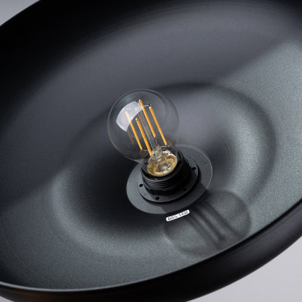 Suspension Pur Gina noir mat en situation au-dessus d'un lit dans une chambre au style scandinave