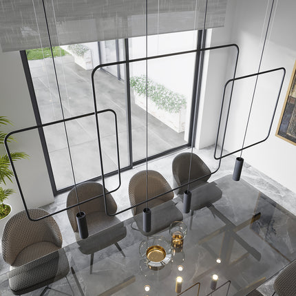Vue plongeante sur des suspensions rectangulaires filaires noires au-dessus d'une table en verre