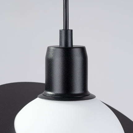 Détail de la douille noire et de l'ampoule G9 LED visible sous le globe de la suspension Saturne.