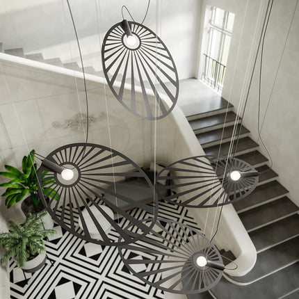 Vue plongeante sur les suspensions Soleil Lumineux noires groupées au-dessus d'un escalier