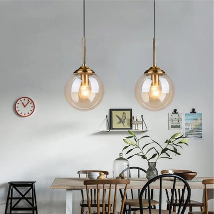 Nordic glass pendant light with golden ring, amber tint