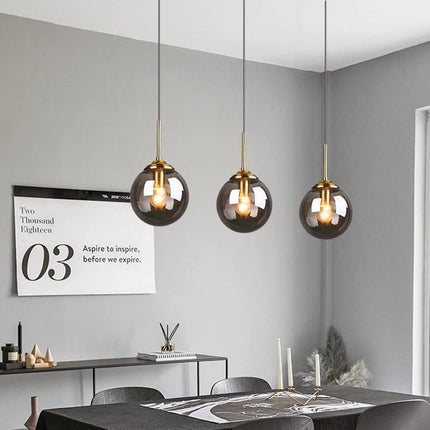 Nordic glass pendant light with golden ring and minimalist design