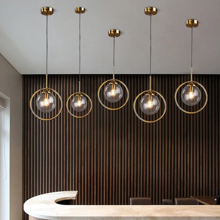 Nordic glass pendant light with golden ring, clear tint