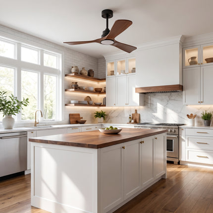 Ventilateur de plafond à pales noyer dans une cuisine blanche à îlot en bois et plan en marbre